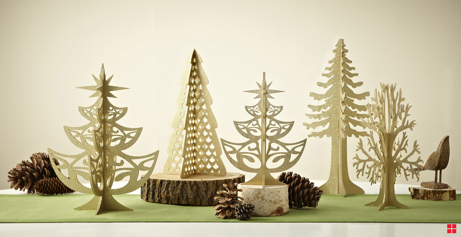 Laser-cut decorative trees covered with gold glitter spray paint. 