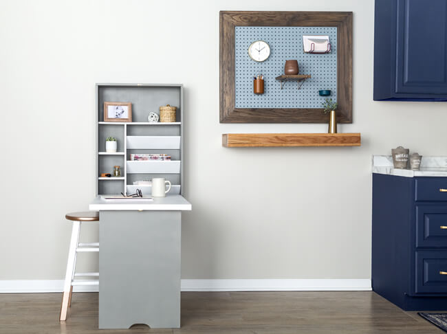 Painted murphy desk open on wall with stool and shelf