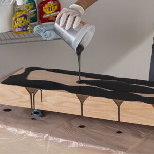 Pouring The Activated Mixture Onto Wood Shelf