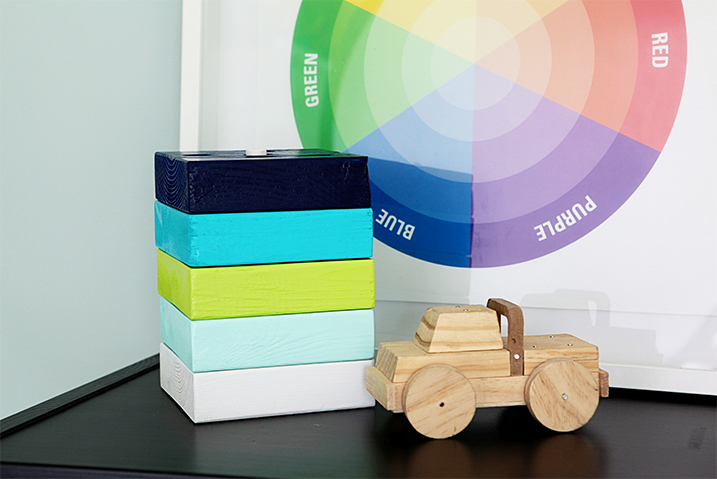 5 wooden blocks painted with Painter's Touch Ultra Cover 2X next to a wooden toy car