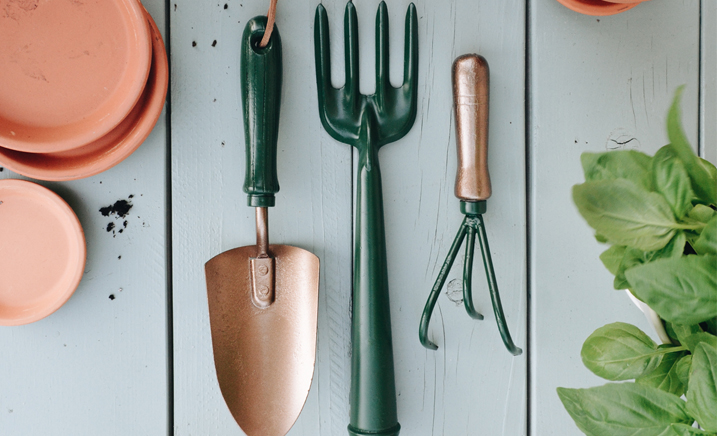 Trowel and hand rakes painted green and copper.