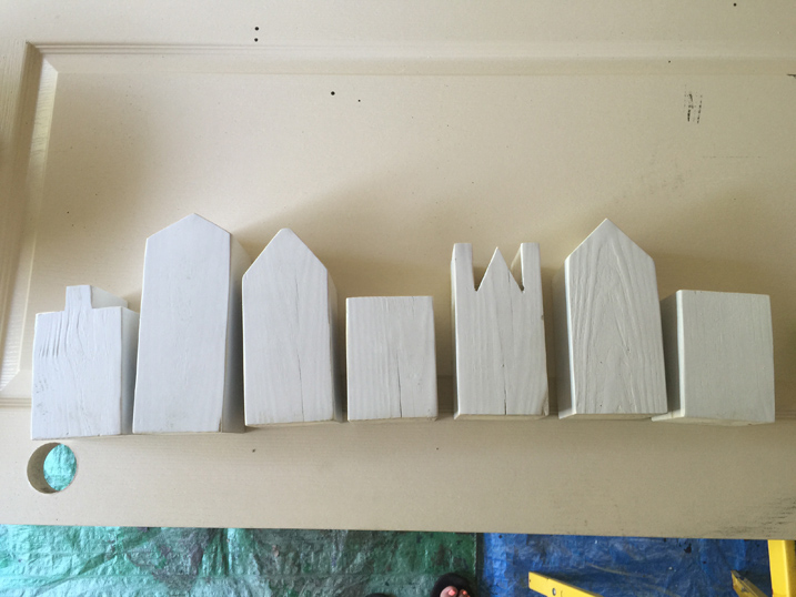 wooden blocks cut to shapes of buildings and painted white