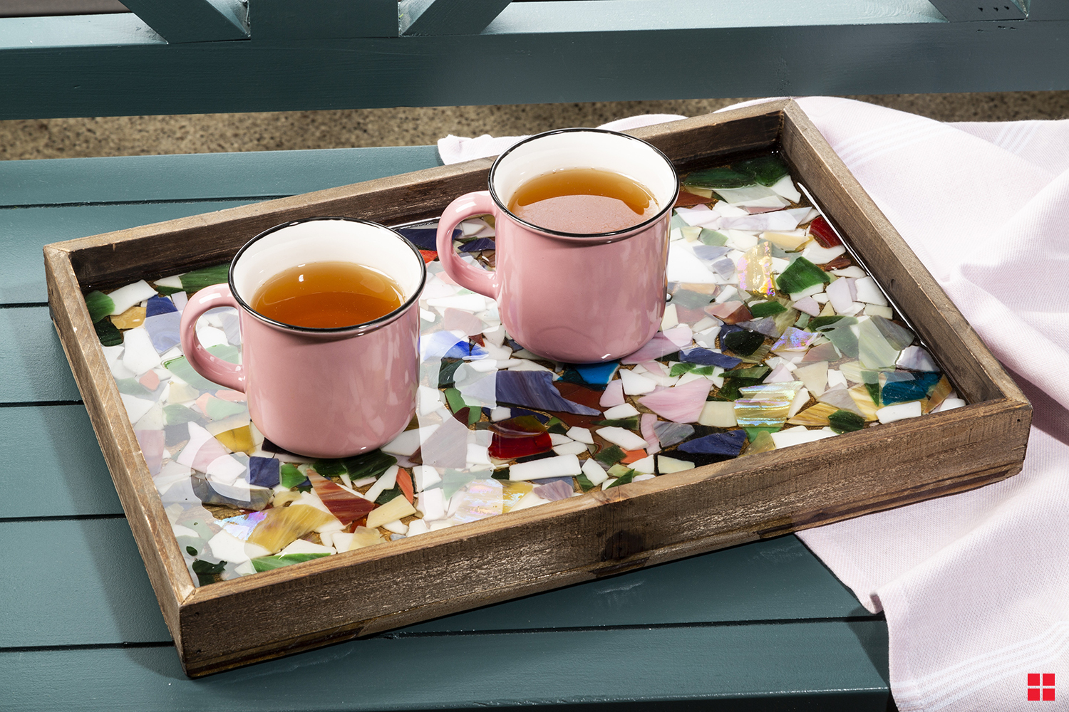 Two coffee cups on top of epoxy resin covered mosaic serving tray.
