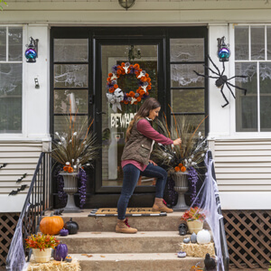 Woman arranging greenery in a decorative urn.
