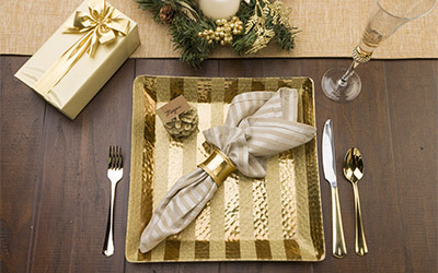 Place setting with glitter stipes painted on a plate charger.