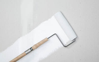 Primer being applied to concrete wall