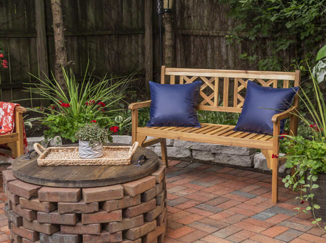 Two blue pillow on a patio bench.