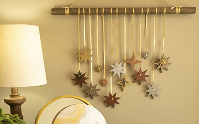 Hanging wall décor featuring metallic painted stars. 