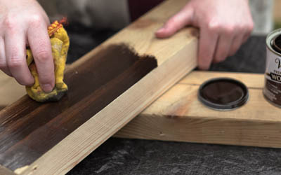 Applying wood stain in a wooden piece