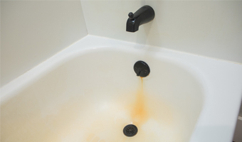 Rust stains on a white bathtub.