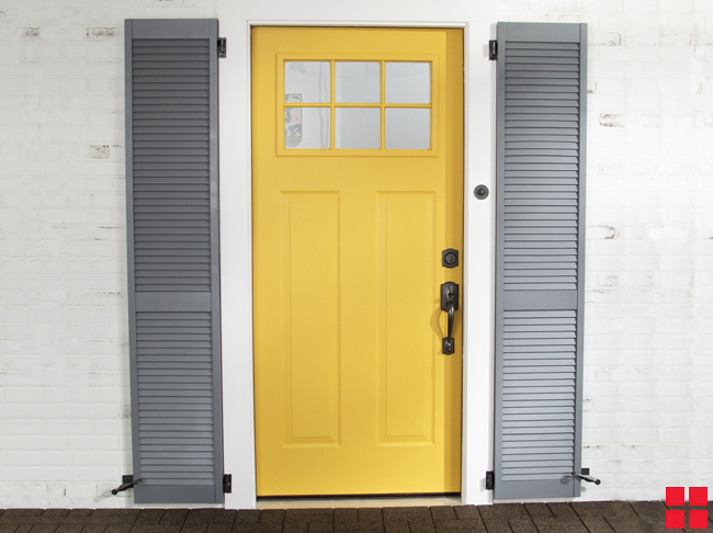 Gray shutters around yellow front door.