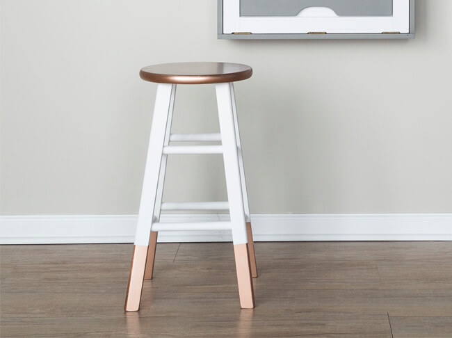 Close-up of stool painted with Chalked and Stops Rust spray paint.