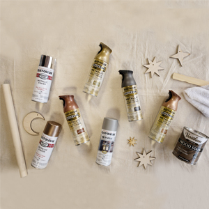 Seven cans of Rust-Oleum spray paint, can of Varathane wood stain and wood pieces.