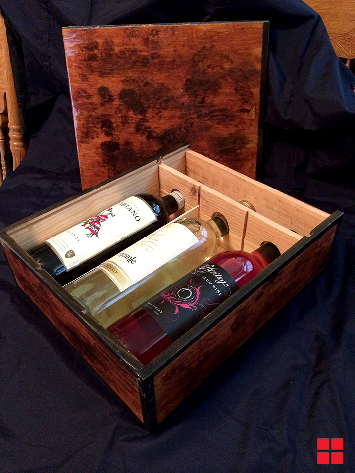 Stained box with bottle of wine insude